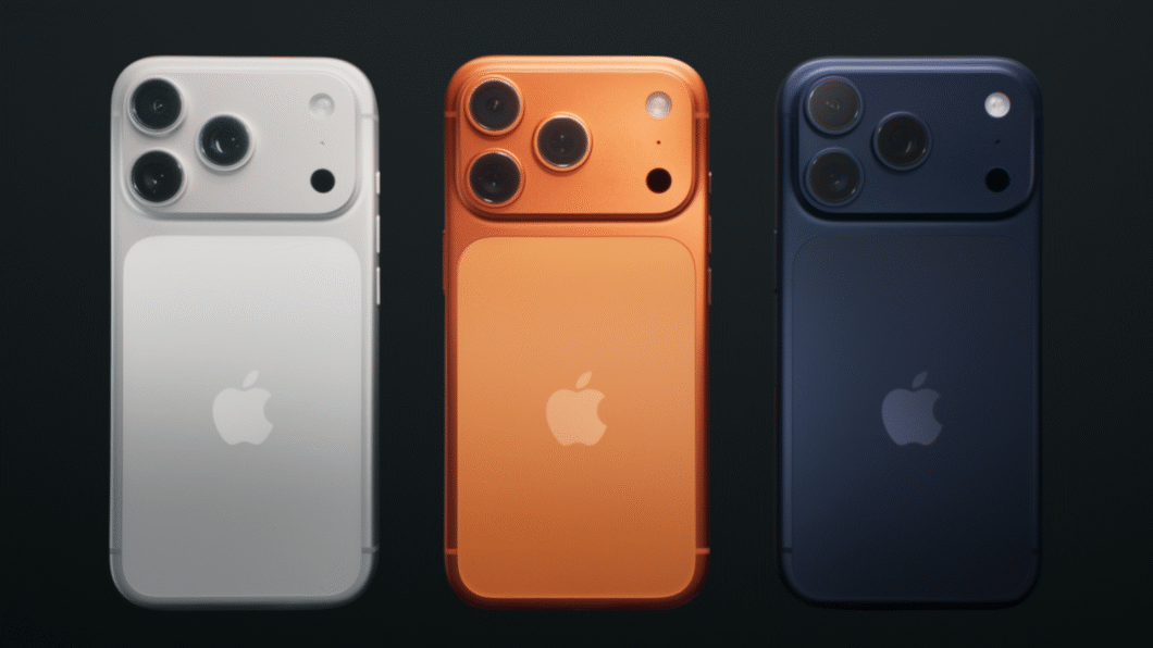 Três smartphones iPhones 17 Pro, com a logo da Apple, são exibidos lado a lado em um fundo escuro. Da esquerda para a direita, os aparelhos são nas cores branca, laranja e azul-escuro. Todos possuem três câmeras e um flash na parte superior esquerda da parte traseira.