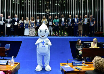 Zé Gotinha posa para foto com parlamentares e convidados.